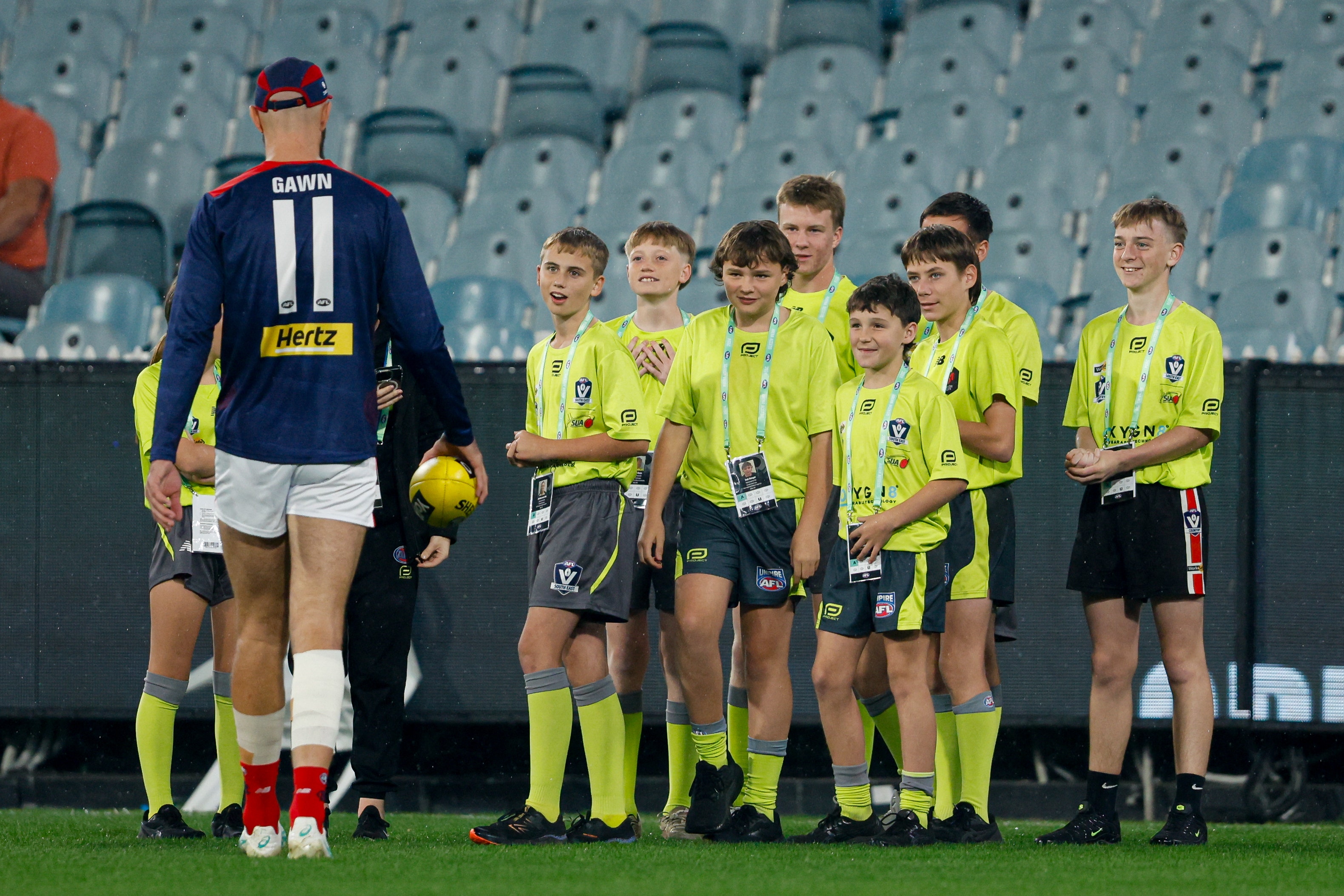 Melbourne's Max Gawn meets a group of junior umpires on the MCG as part of Community Umpiring Week in 2024 Photo: AFL Photos / Dylan Burns